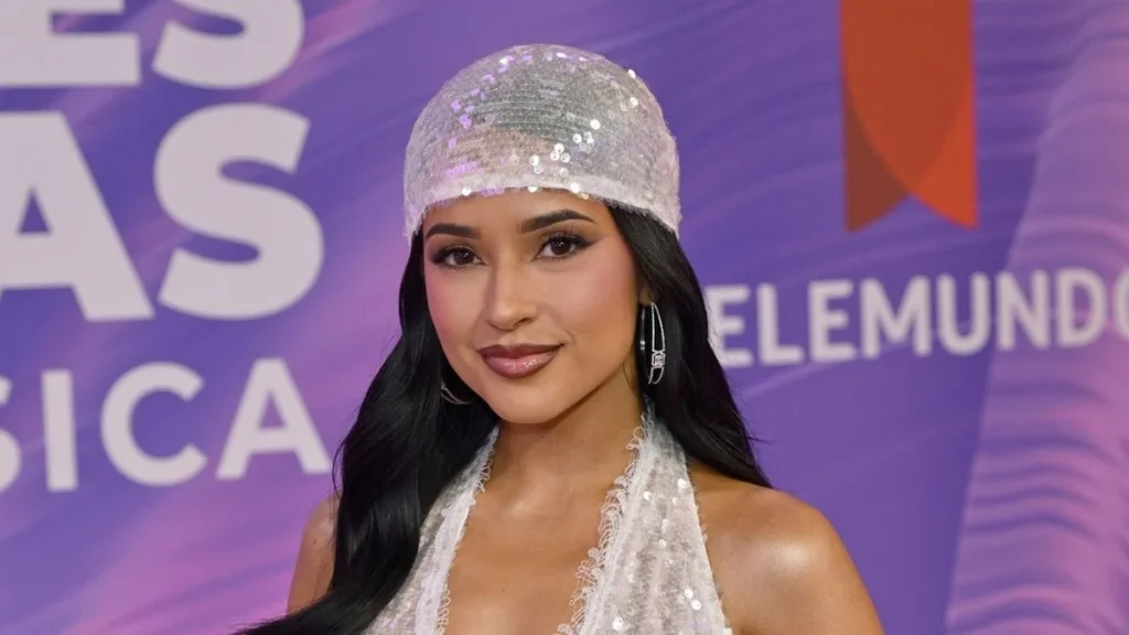 Becky G Redefines Modern Tailoring by Integrating the Peekaboo Bra Trend into a Sophisticated Suit Ensemble for Maybelline Campaign