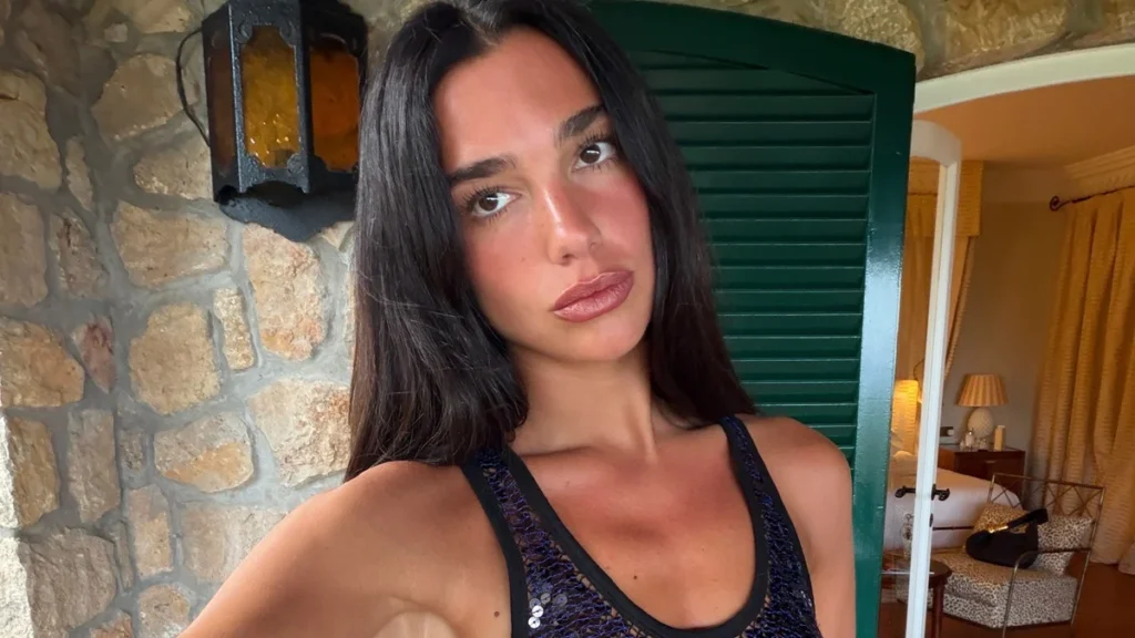 Dua Lipa Unveils The Manifesto Library Collaboration with Livraria Lello in Sheer Chloe Peplum Ensemble