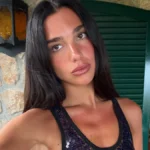 Dua Lipa Unveils The Manifesto Library Collaboration with Livraria Lello in Sheer Chloe Peplum Ensemble