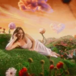 Hilary Duff gets sultry in low-cut Collina Strada dress with sheer lace cutout in CATastrophe MV