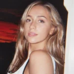 Tate McRae flashed her lacy bra under a completely see-through Valentino lace tank top in Paris